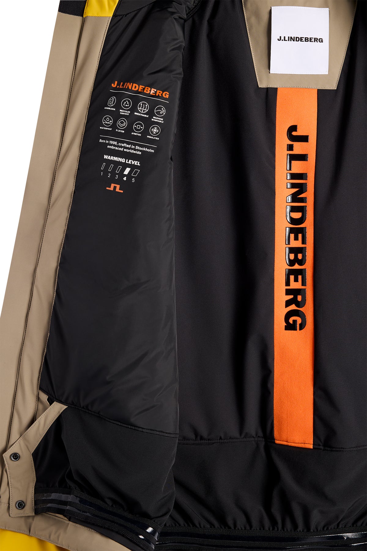 Nærbillede: Indersiden af Caldwell Jacket i Bumblebee med sort for, orange logostribe og sneskørt.