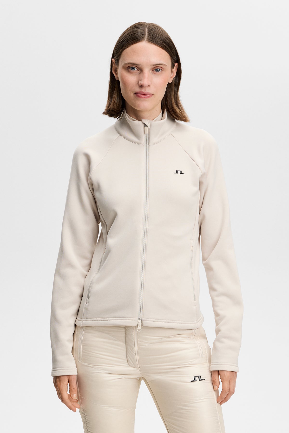 Portia Polartec Mid Layer in Moonbeam, front view with high neck, full zip, and Bridge logo.