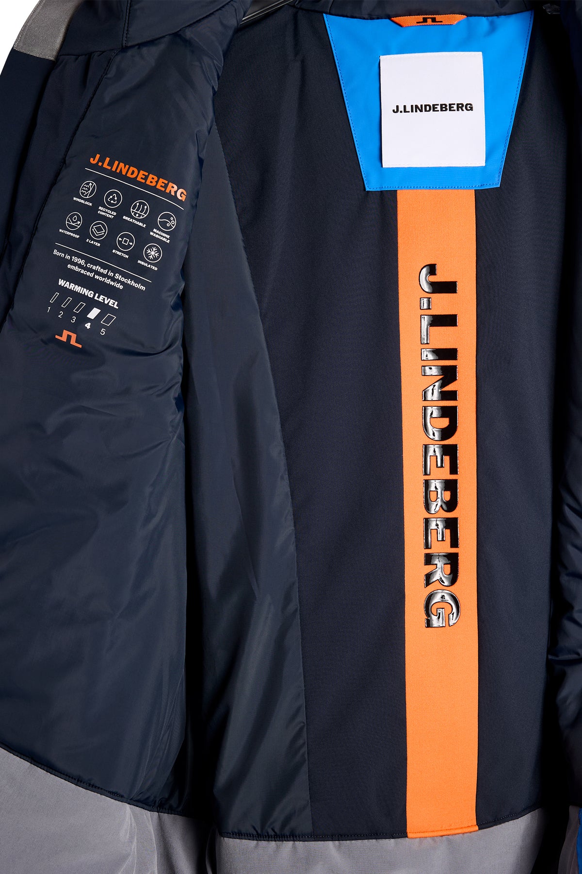 Close-up of the Windsor Jacket interior in Sonic Blue showing J.LINDEBERG branding and technical details.