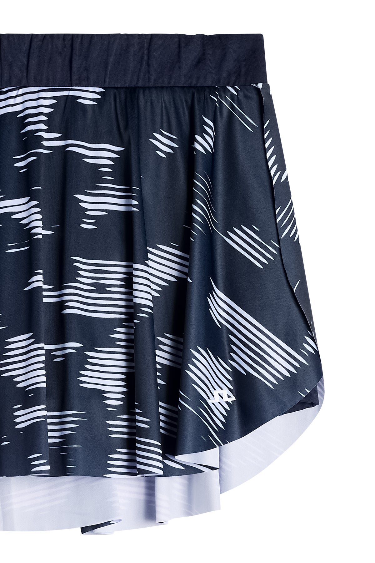 Close-up: Feilia Print Skirt in Clay Purple Heather met grafische print en Bridge-logo op de zoom.