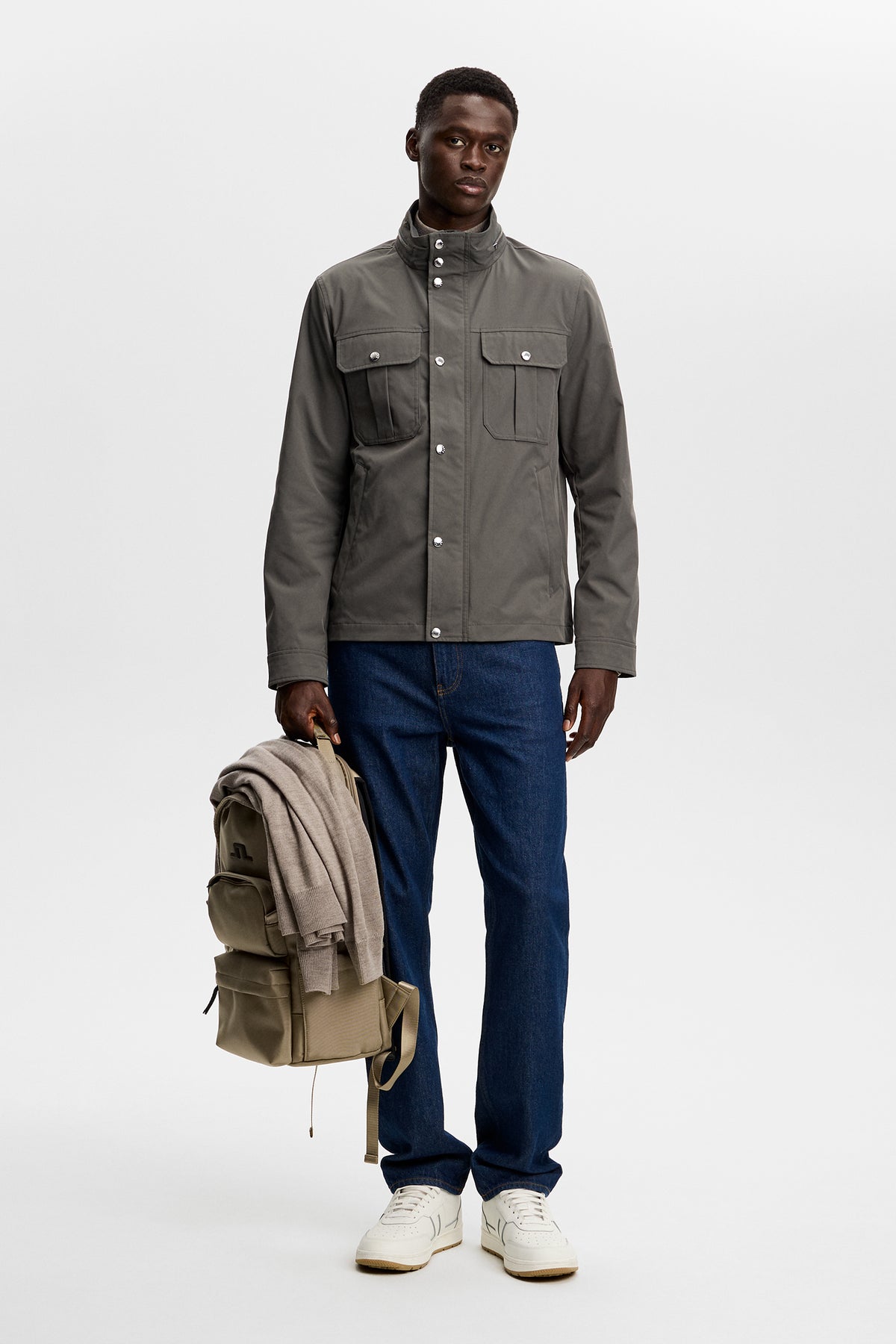 Model wearing the Bailey Recy Poly Jacket in Chimera with chest flap pockets in a studio setting.