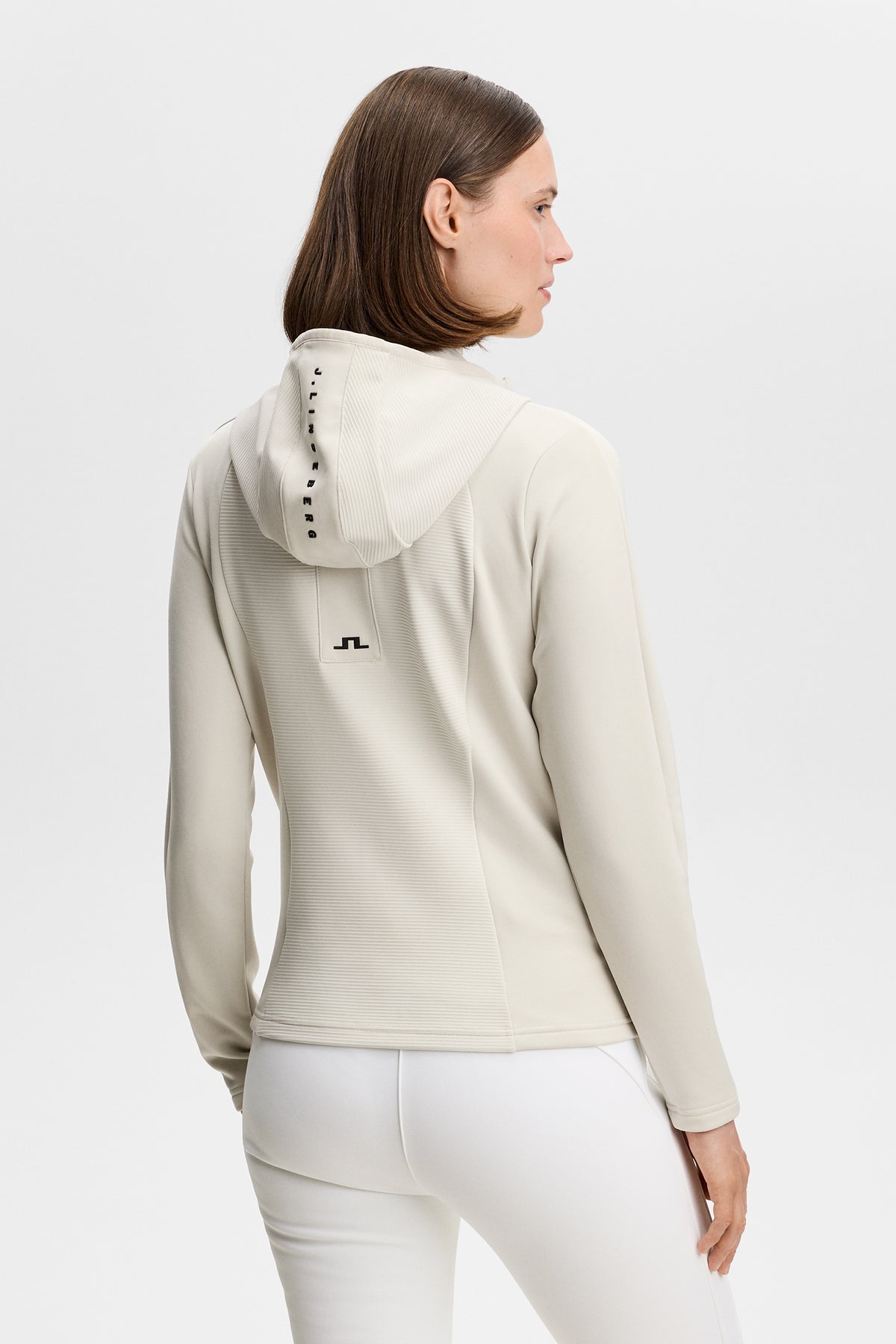 Mireya Full Zip Hood in Moonbeam, back view showing ribbed panels and Bridge logo.