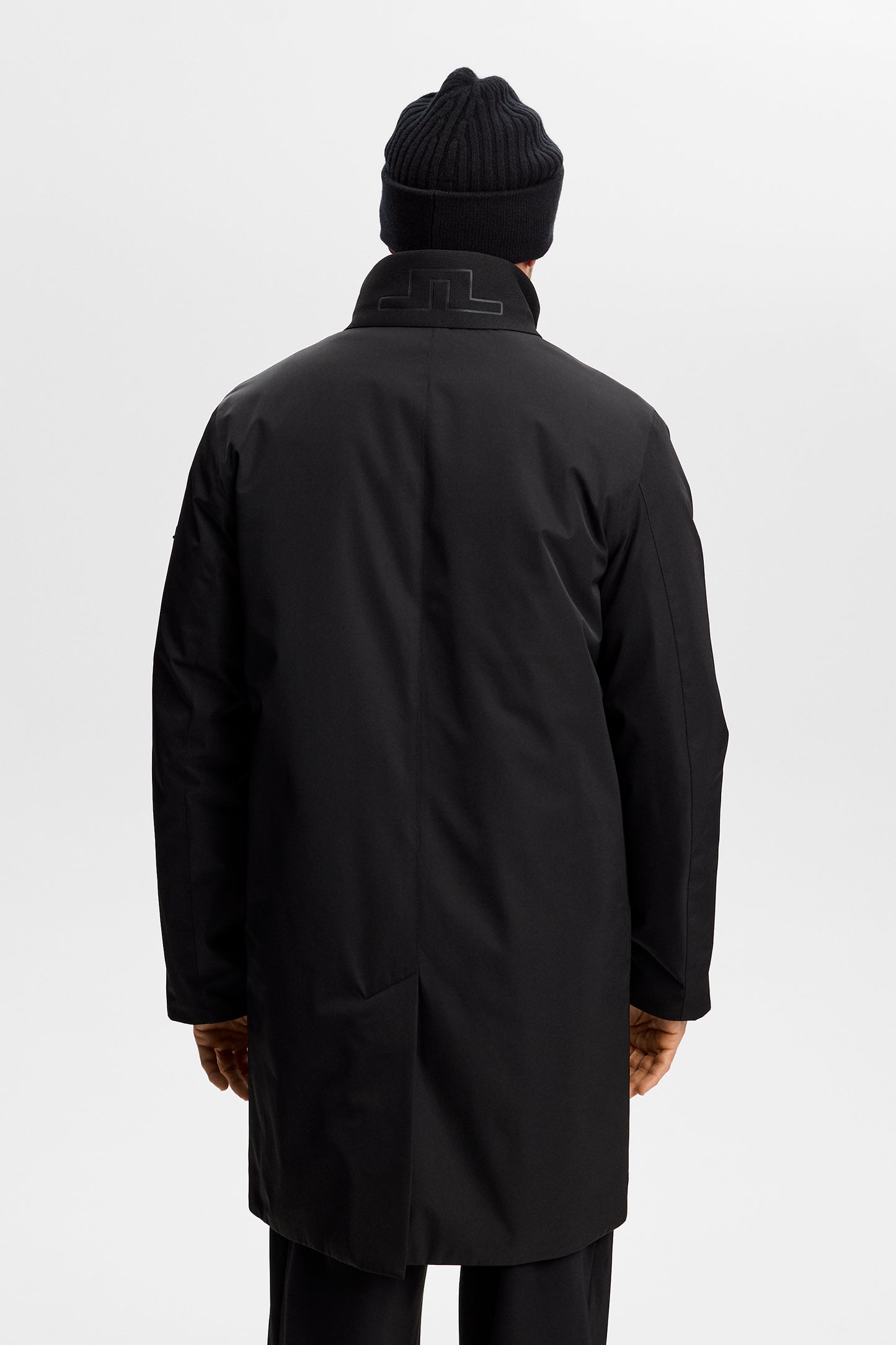 Back view: Black Harold Padded Jacket featuring a mid-length fit and a tonal Bridge logo on the collar.