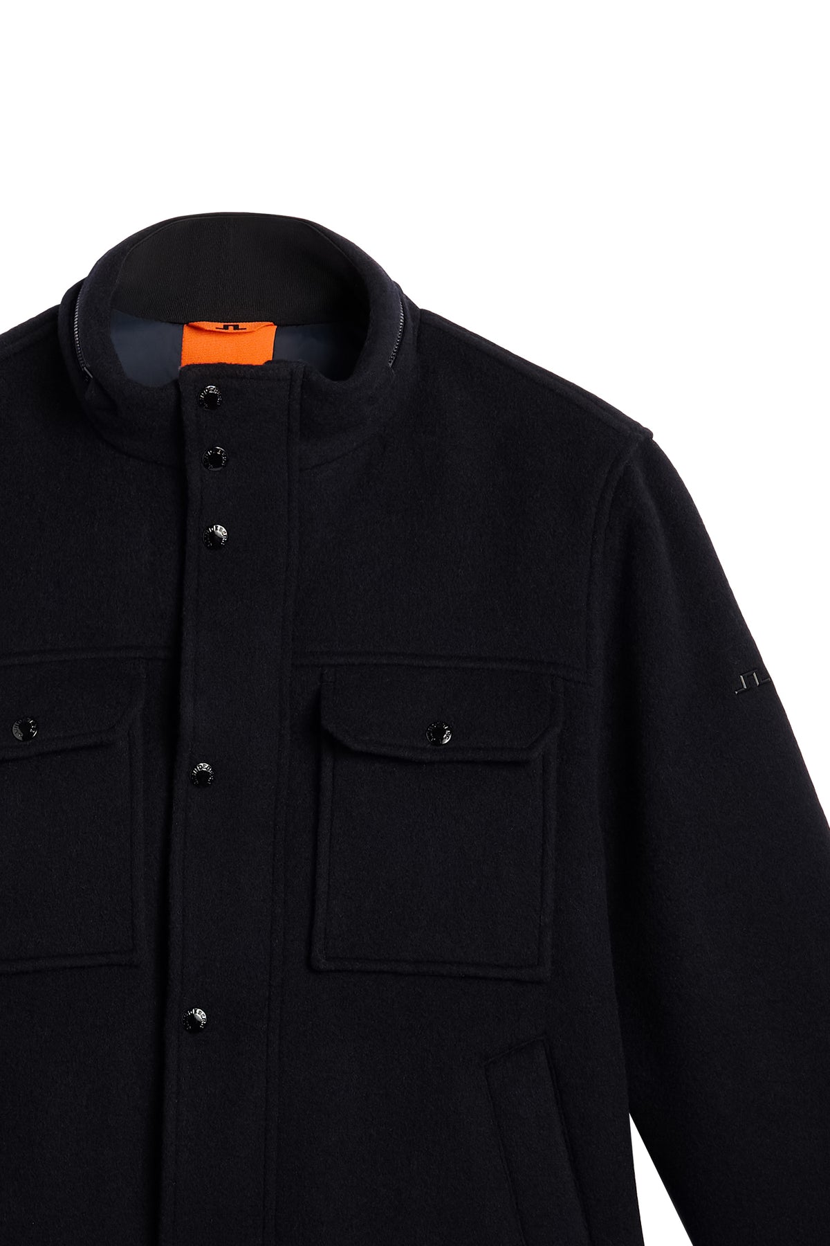 Close-up of the Bailey Wool Jacket in JL Navy with snap buttons, flap pockets, and sleeve Bridge logo.