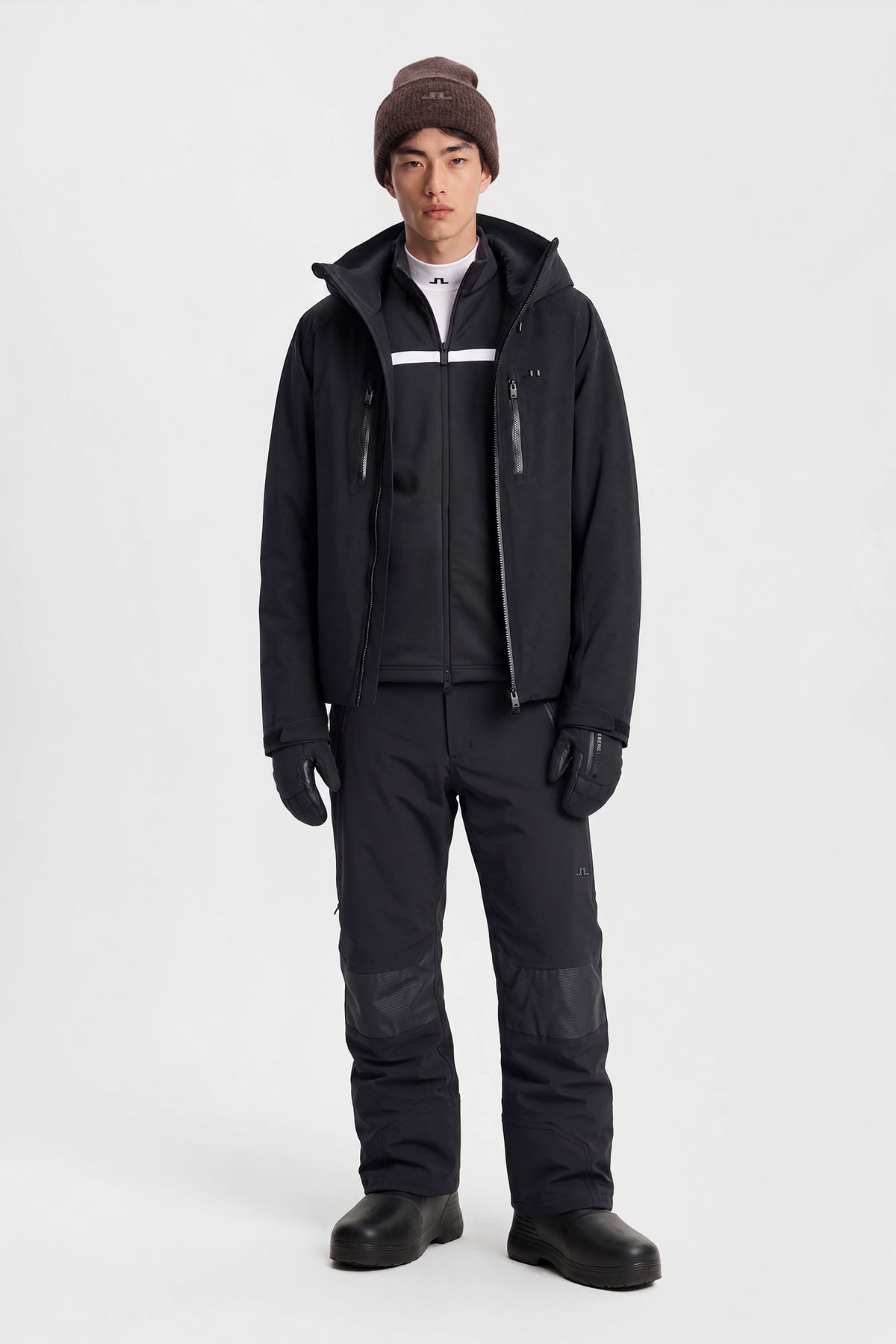 Front view: Model wearing the black Whitman Pant with Bridge logo in a studio setting.