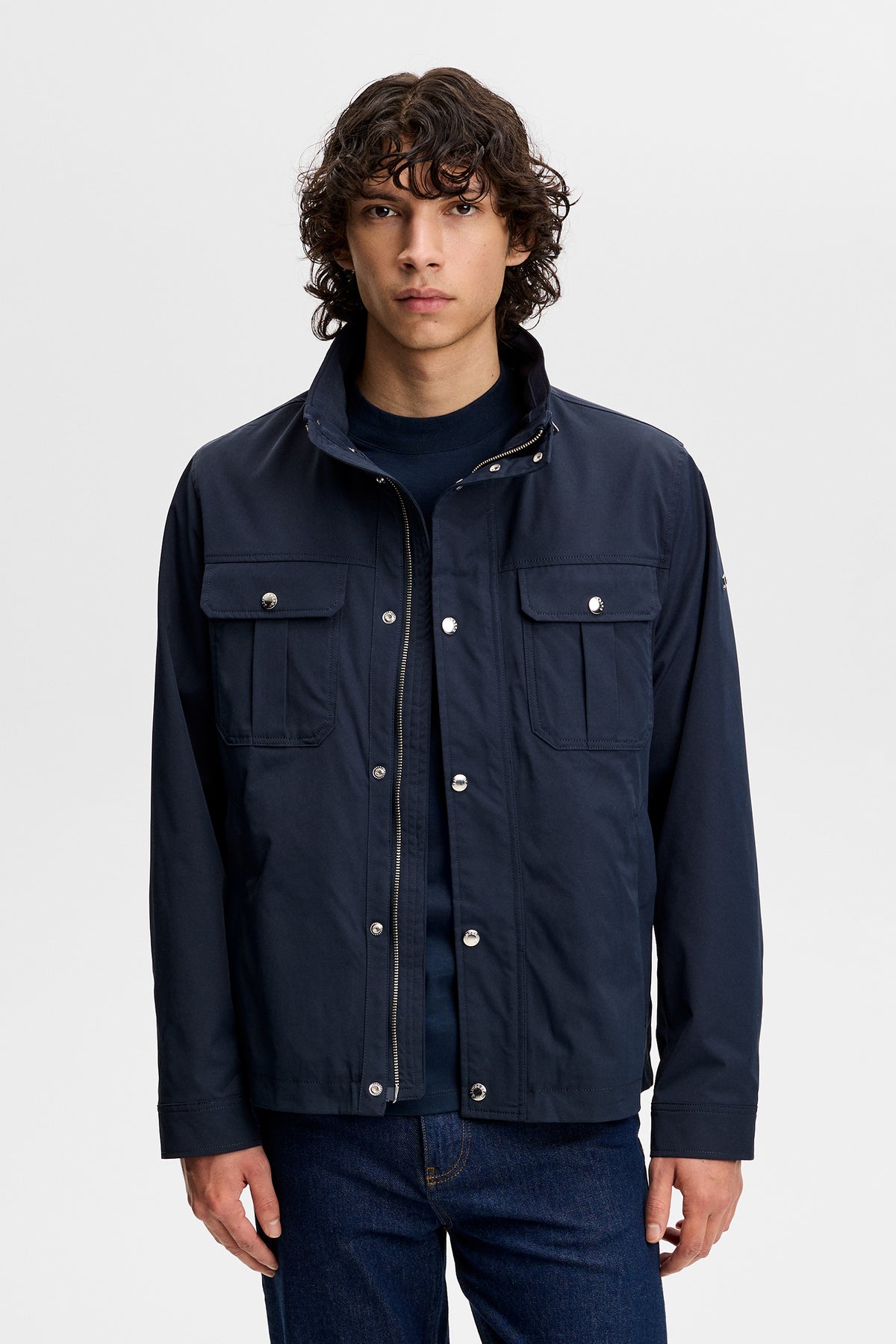 Front view of the Bailey Recy Poly Jacket in JL Navy with chest pockets, stand collar, and snap-button placket.