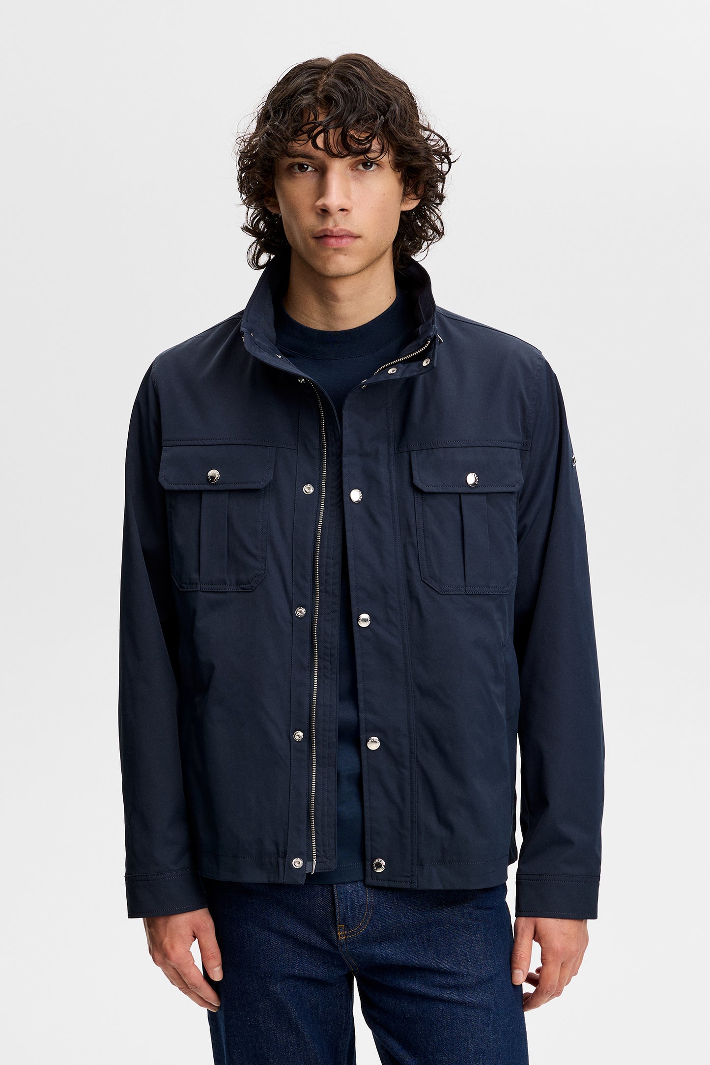 Front view of the Bailey Recy Poly Jacket in JL Navy with chest pockets, stand collar, and snap-button placket.