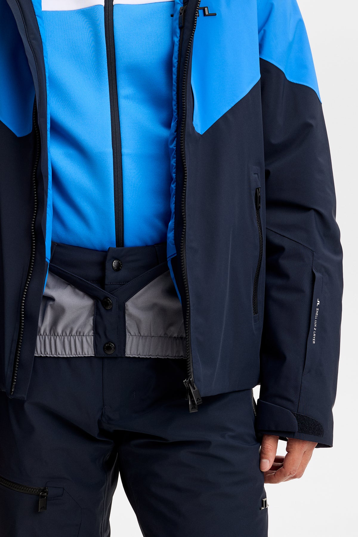Detailansicht: Caldwell Jacket in Sonic Blue, geöffnet mit integriertem Schneefang und Reißverschluss.