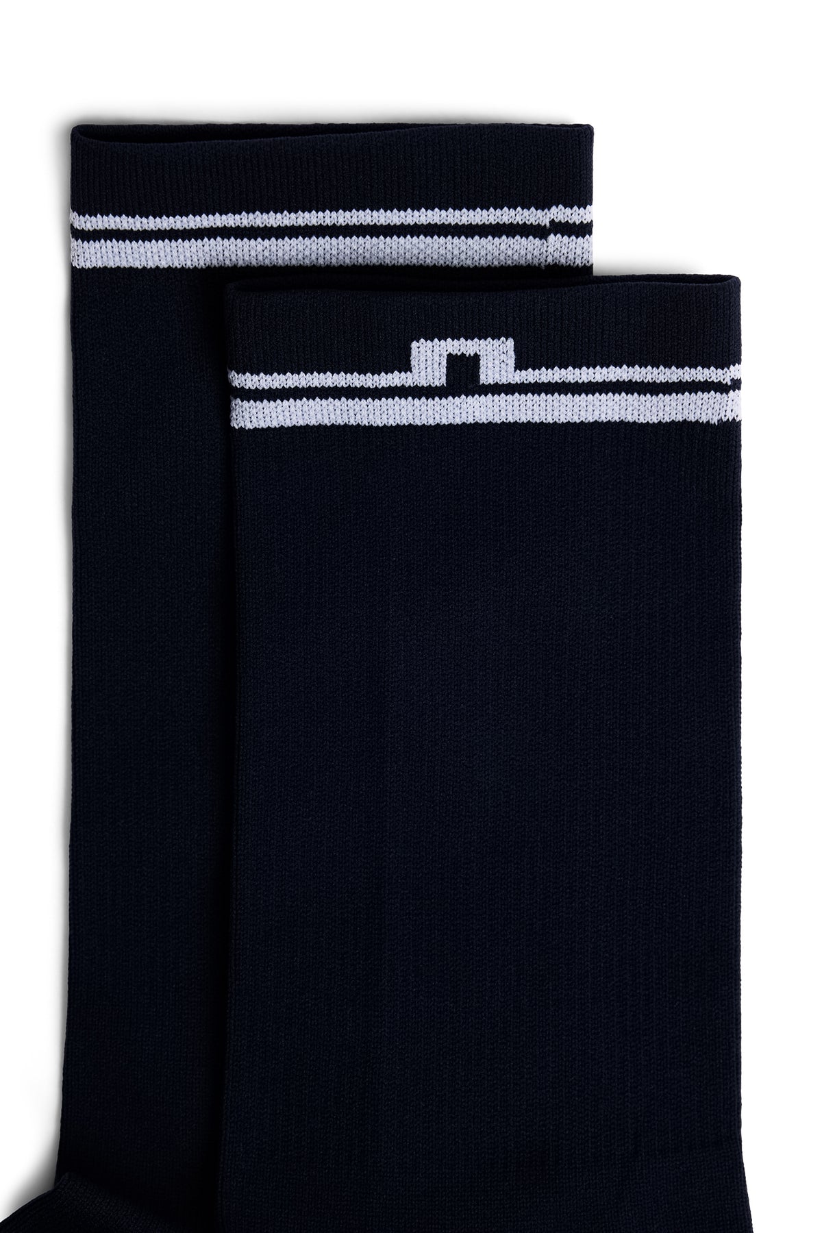 Close-up of the Players Sock in JL Navy showing the ribbed cuff, white stripe, and Bridge logo.