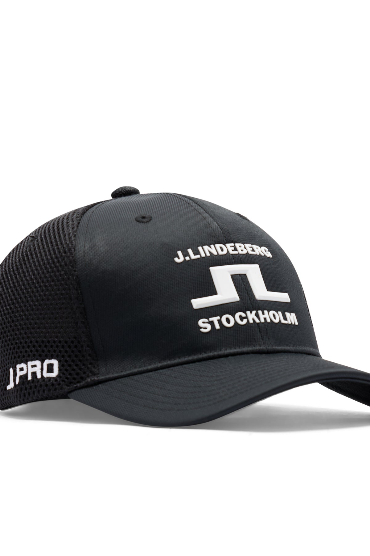Nærbilde: Svart JL Pro Cap med hvit 3D Bridge-logo i front og pustende mesh-panel på siden.