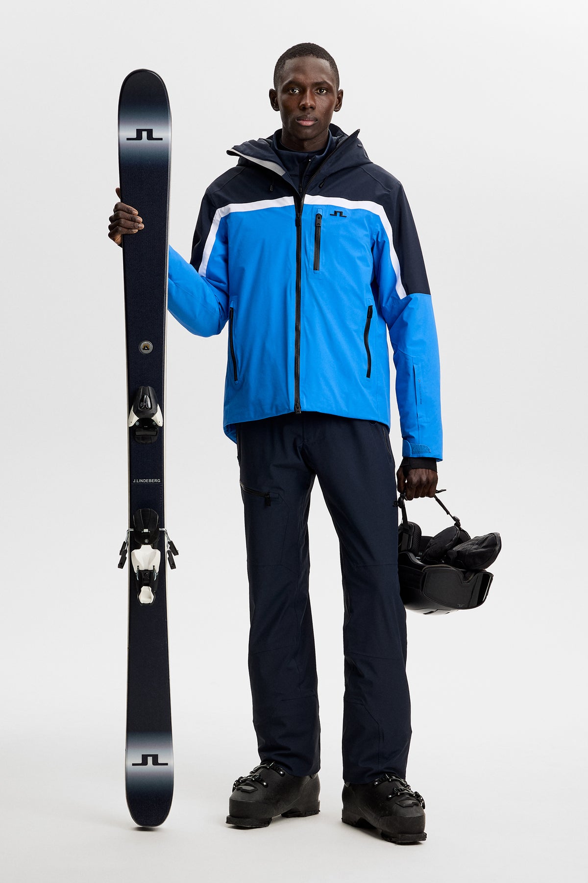 Front view: Model wearing the Windsor Jacket in Sonic Blue with color-block panels.