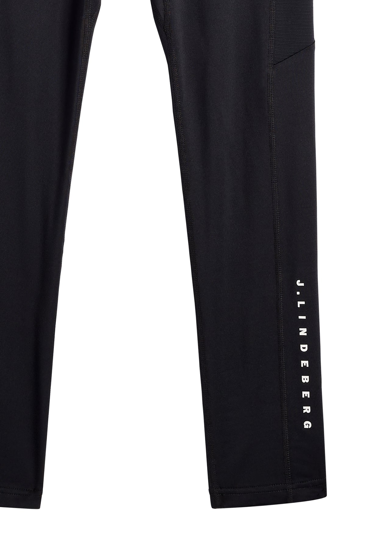 Close-up of the Zenit Baselayer Pant in JL Navy, showing the vertical J.LINDEBERG logo on the lower leg.
