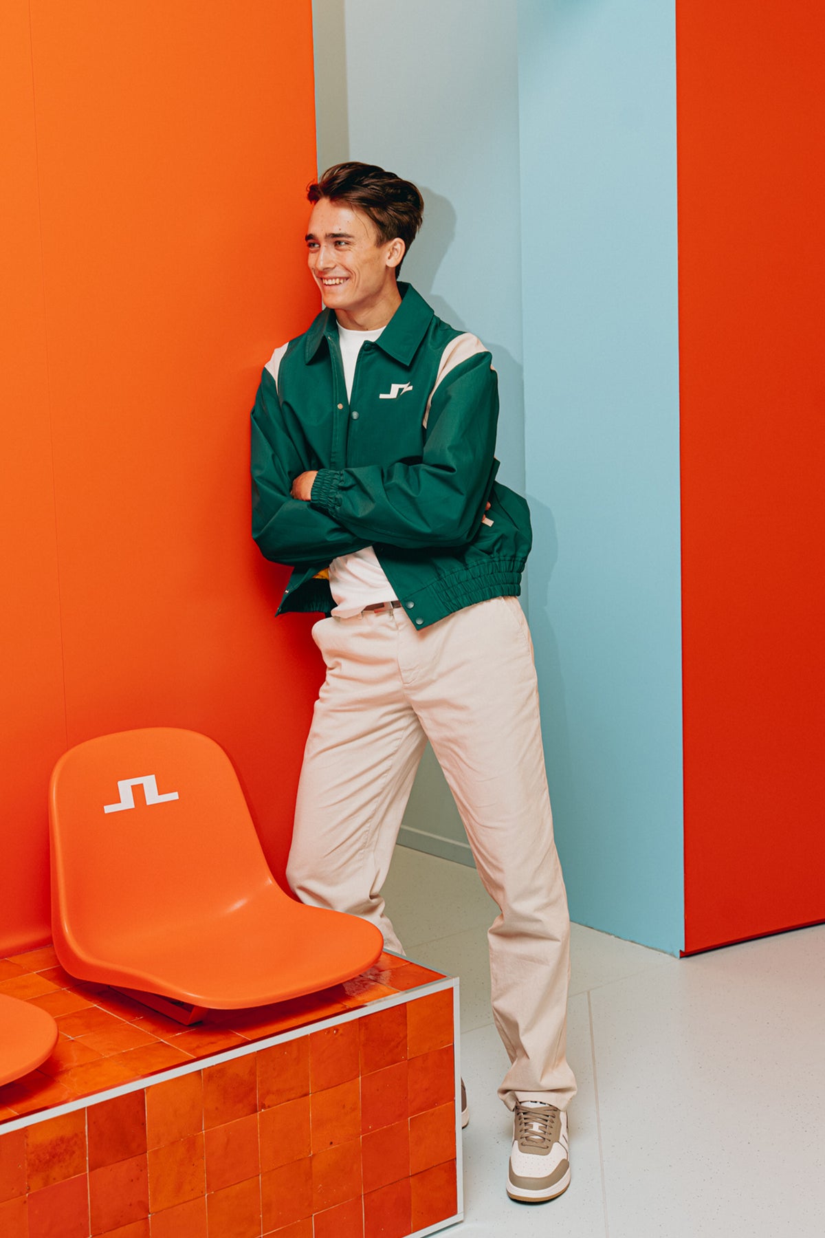 Dino Beganovic wearing a J.LINDEBERG lifestyle look, Bridger Tour Jacket, and Logan Cotton Twill Pants.