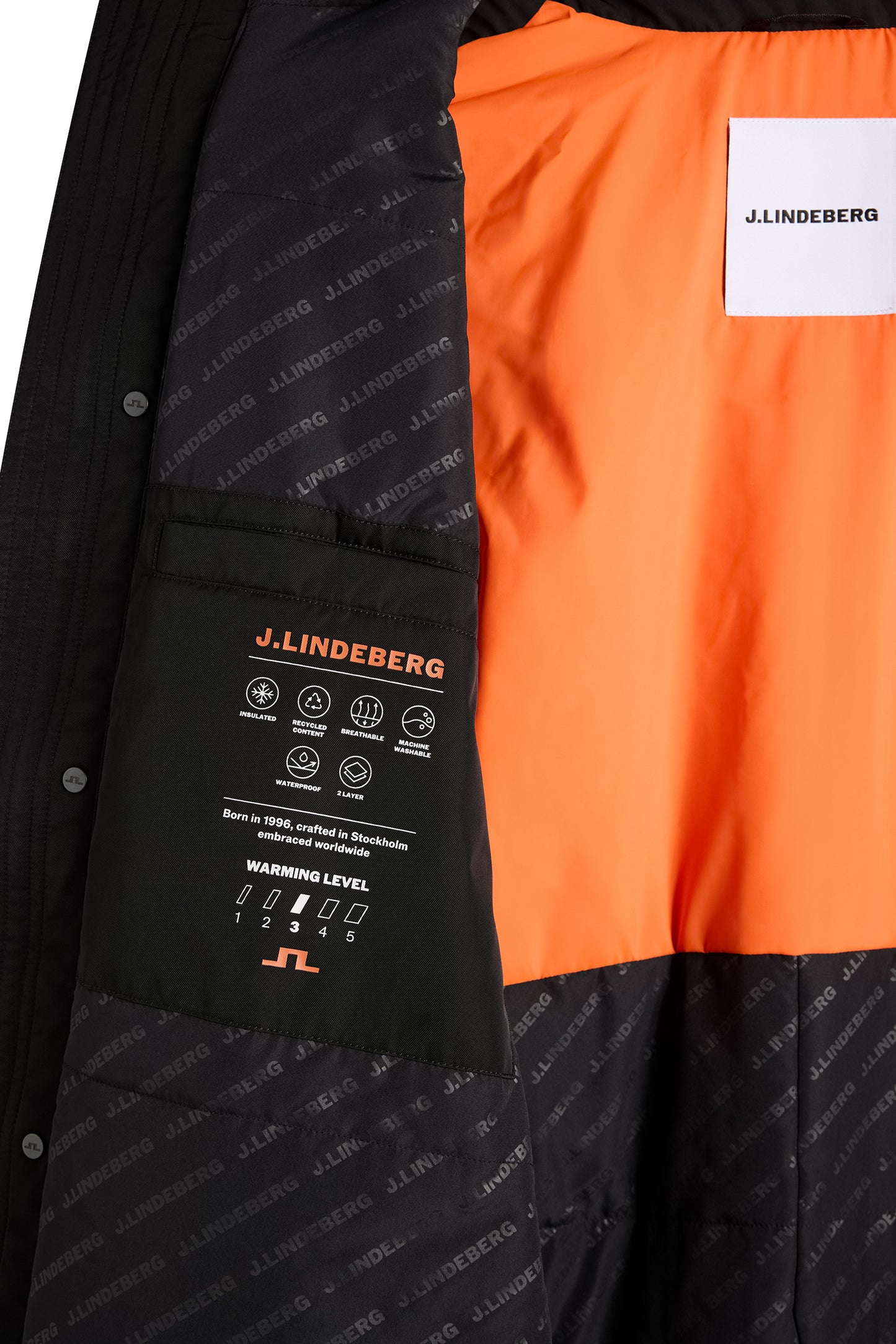 Harold Padded Jacket in black, interior close-up showing the bright orange lining, logo print, and detailed inner pocket.