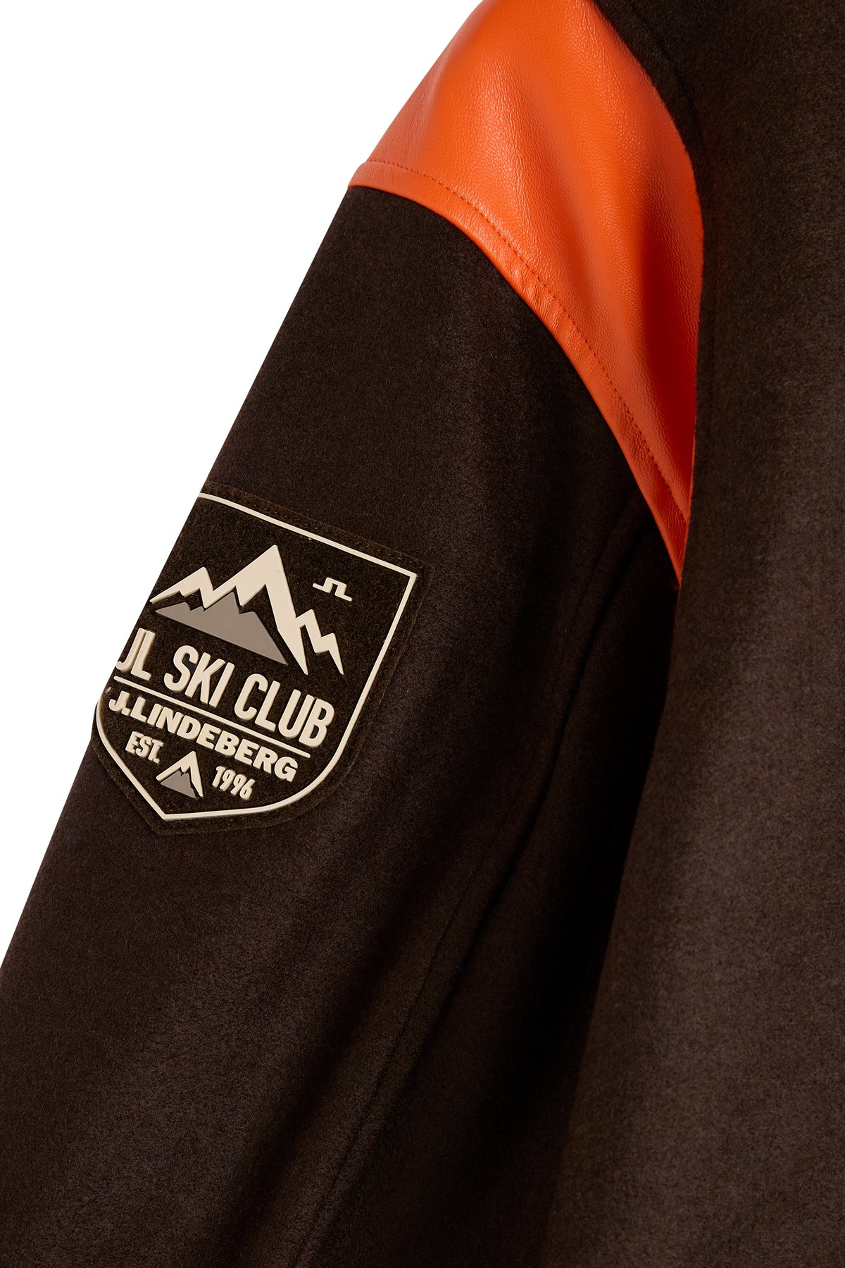 Close-up of the Bobby Bomber Jacket in Seal Brown, showing the JL Ski Club sleeve patch and orange detail.