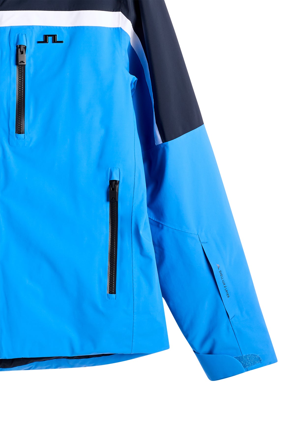 Close-up of the Windsor Jacket in Sonic Blue showing the chest Bridge logo and zippered pockets.