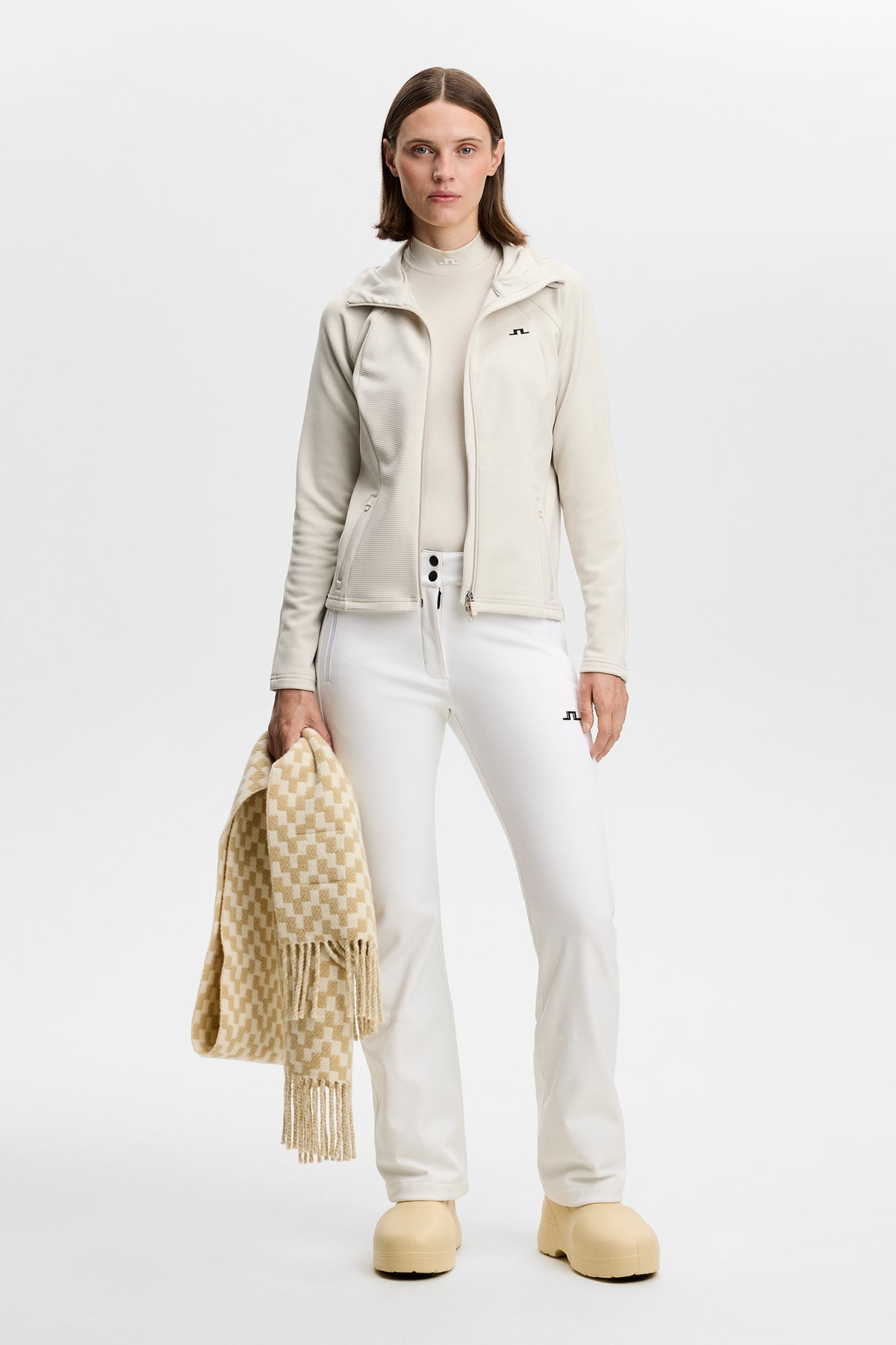 Front view: Model wearing the Mireya Full Zip Hood in Moonbeam in a studio setting.