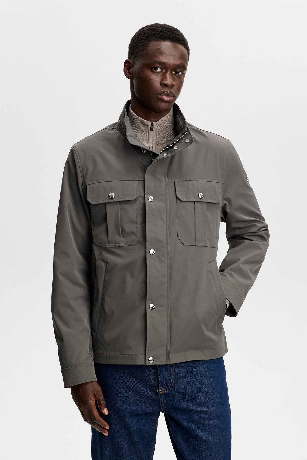 Bailey Recy Poly Jacket in Chimera green, front view with snap placket, high collar, and chest flap pockets.