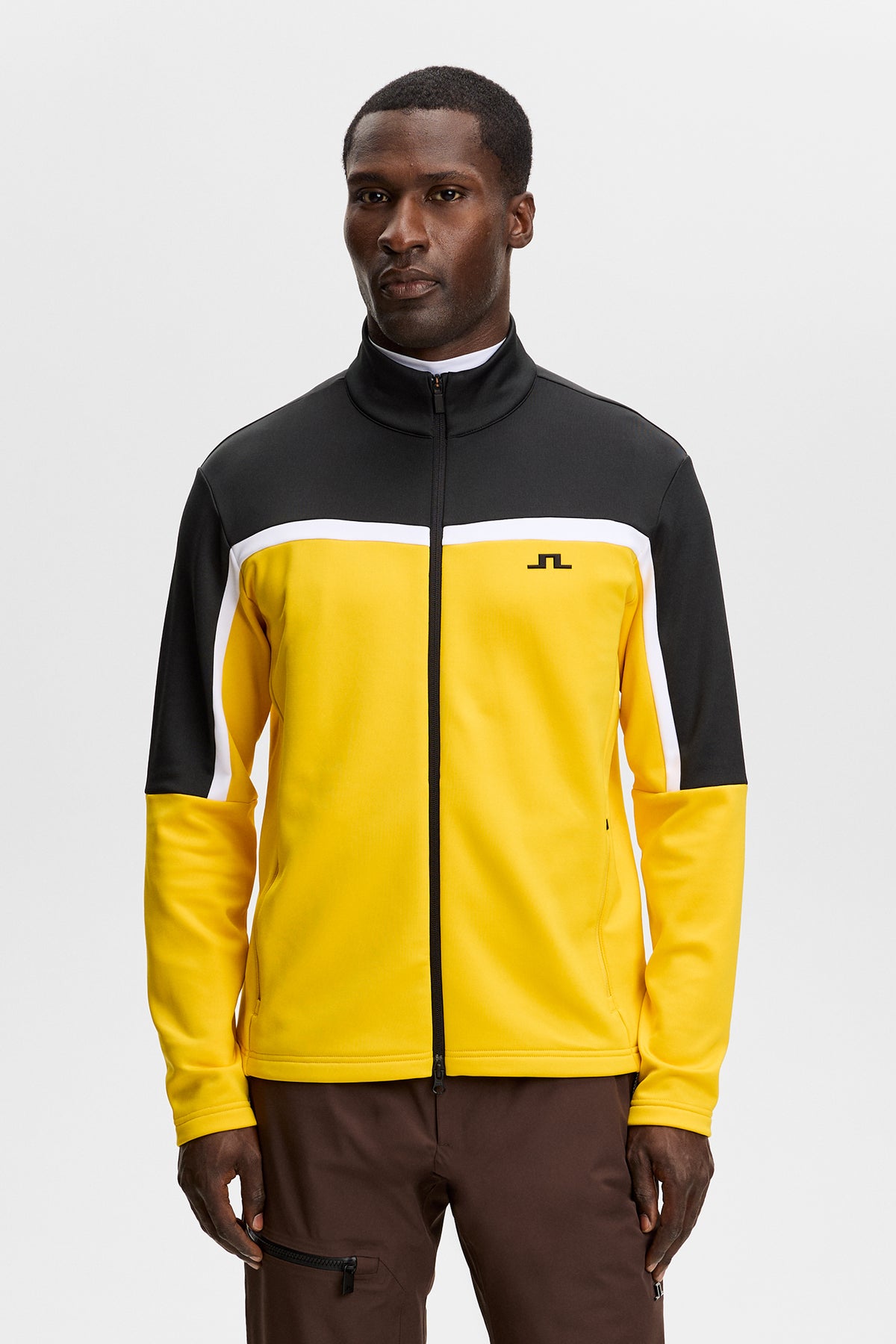 Vue de face : Sharpe Full Zip Mid Layer jaune et noir avec fermeture zippée et logo Bridge sur la poitrine.
