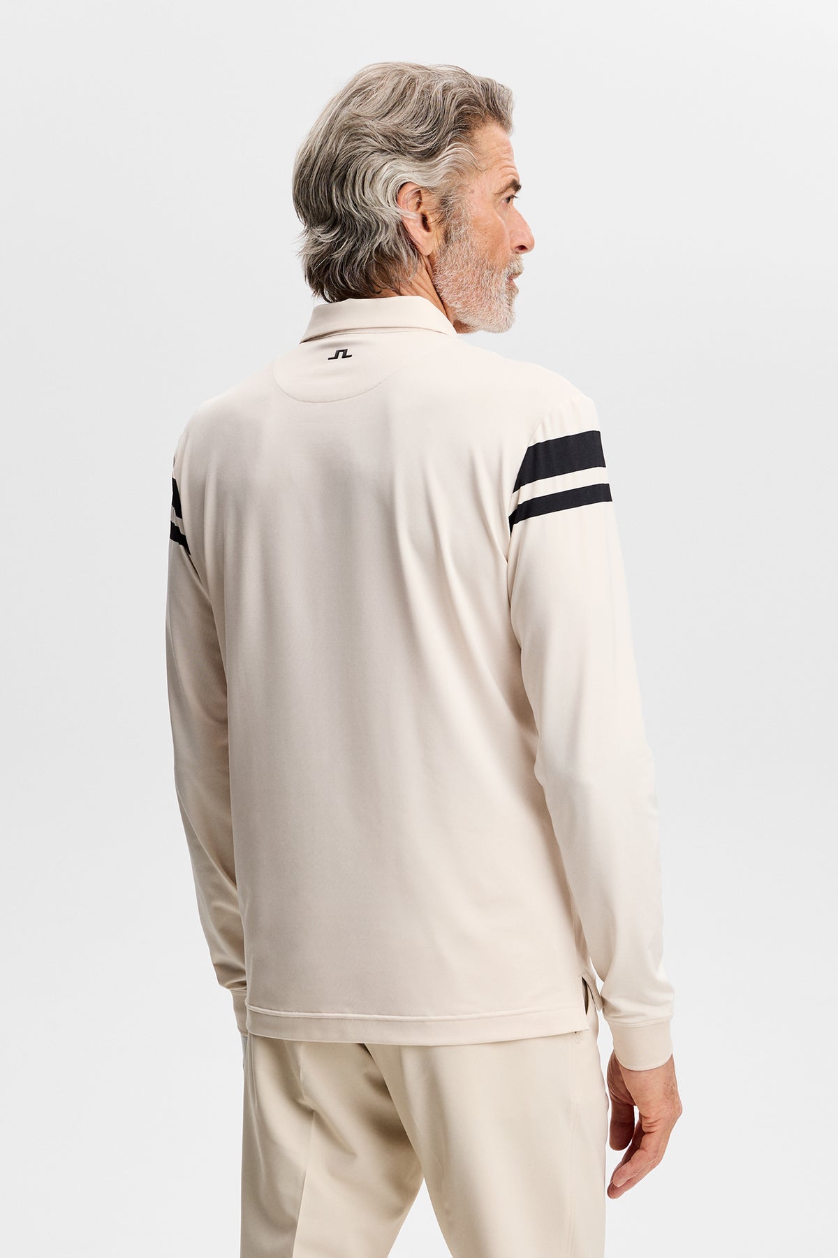 Kenny LS stripe polo in cream, back view on a model showing striped sleeves and a small Bridge logo below the collar.