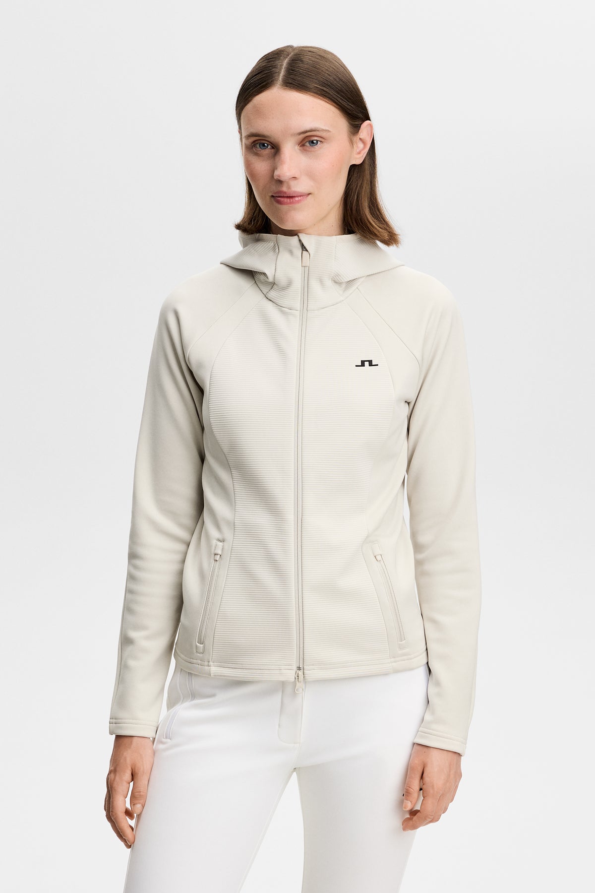 Mireya Full Zip Hood in Moonbeam, front view featuring high neck, full zipper, and Bridge logo.