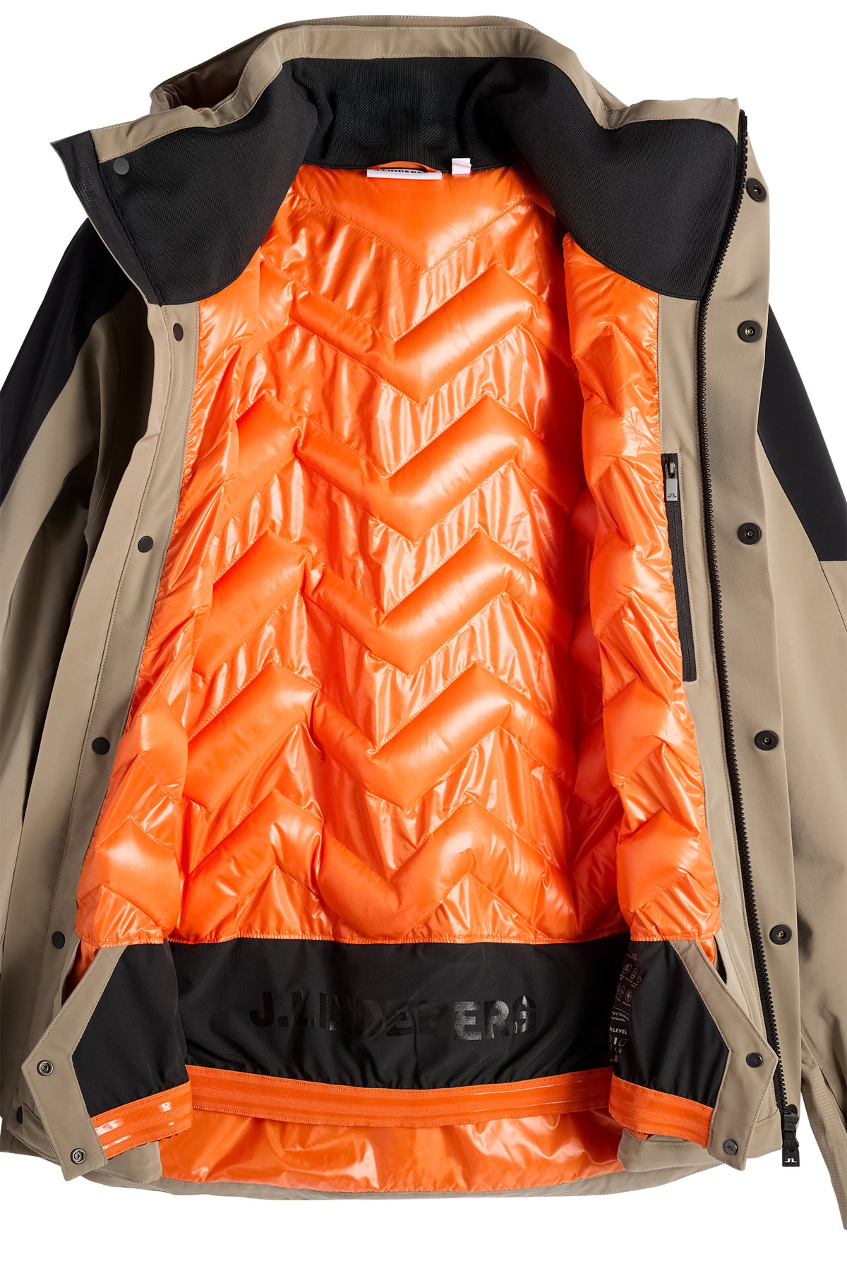 Nærbillede: Indersiden af Greyson Down Jacket i Brindle med orange quiltet for og indvendigt snefang.