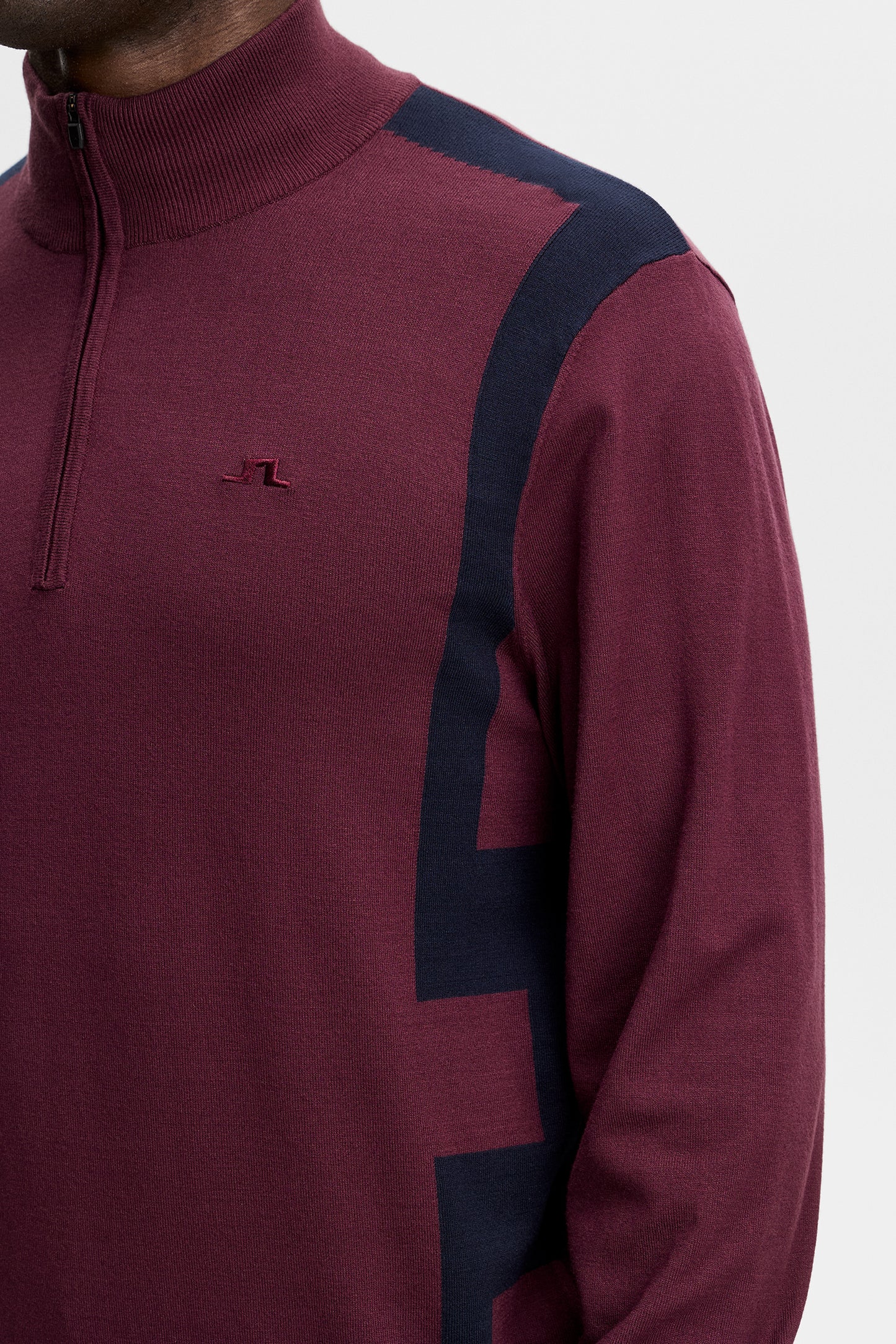 Nahaufnahme: Kendrick Knitted Zip Sweater in Winetasting mit Half-Zip, geripptem Kragen und Bridge-Logo auf der Brust.