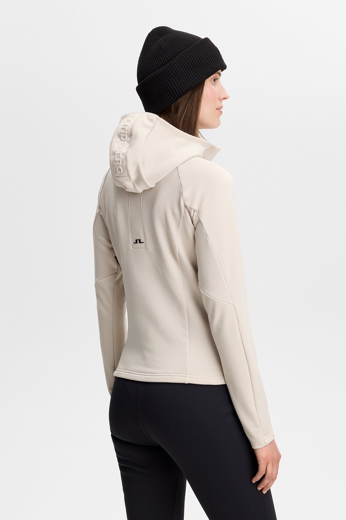 Portia Polartec Hood in Moonbeam, back view showing the hood and Bridge logo on the back.