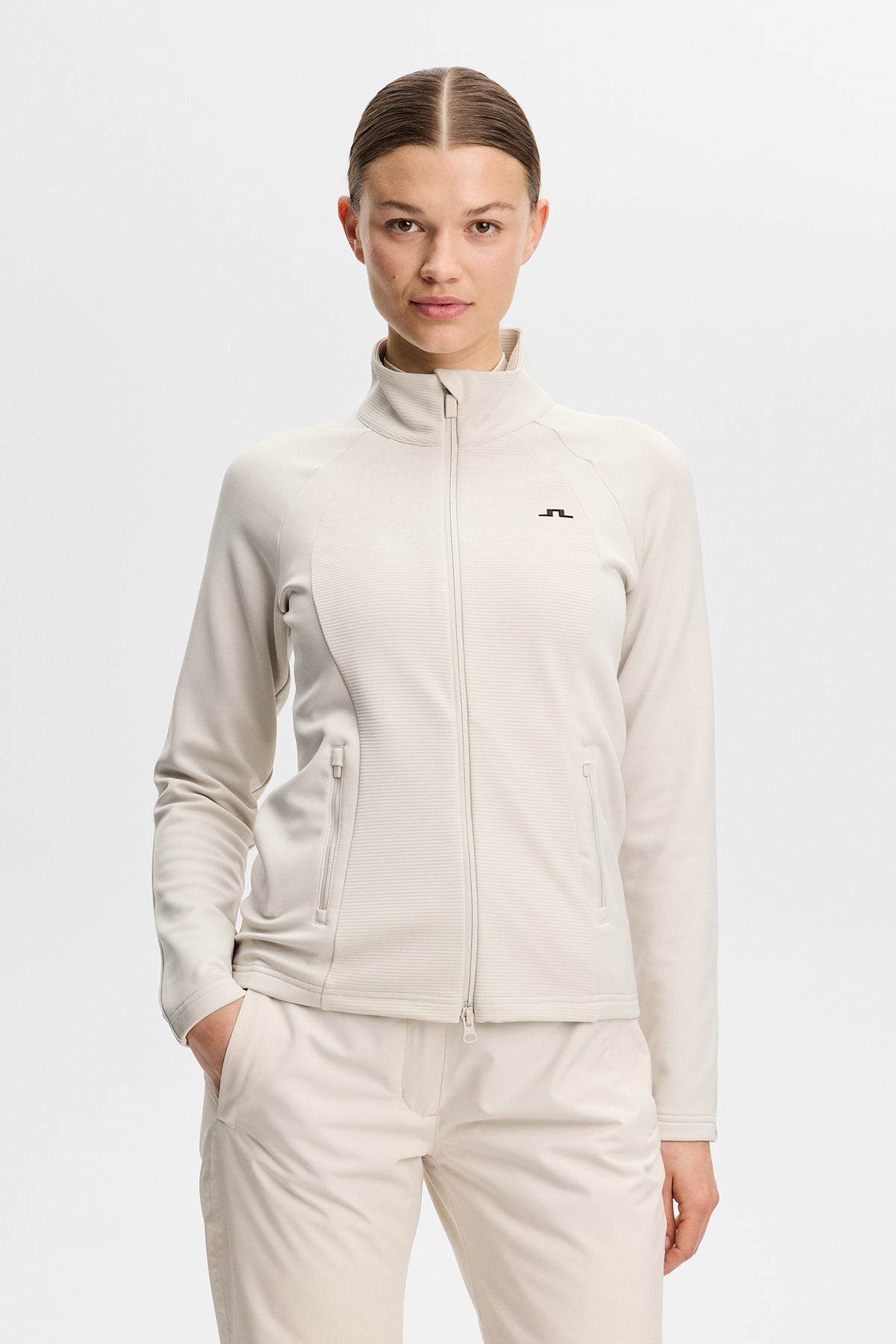 Front view: Mireya Full Zip Mid Layer in Moonbeam with mock neck, full zipper, and chest Bridge logo.