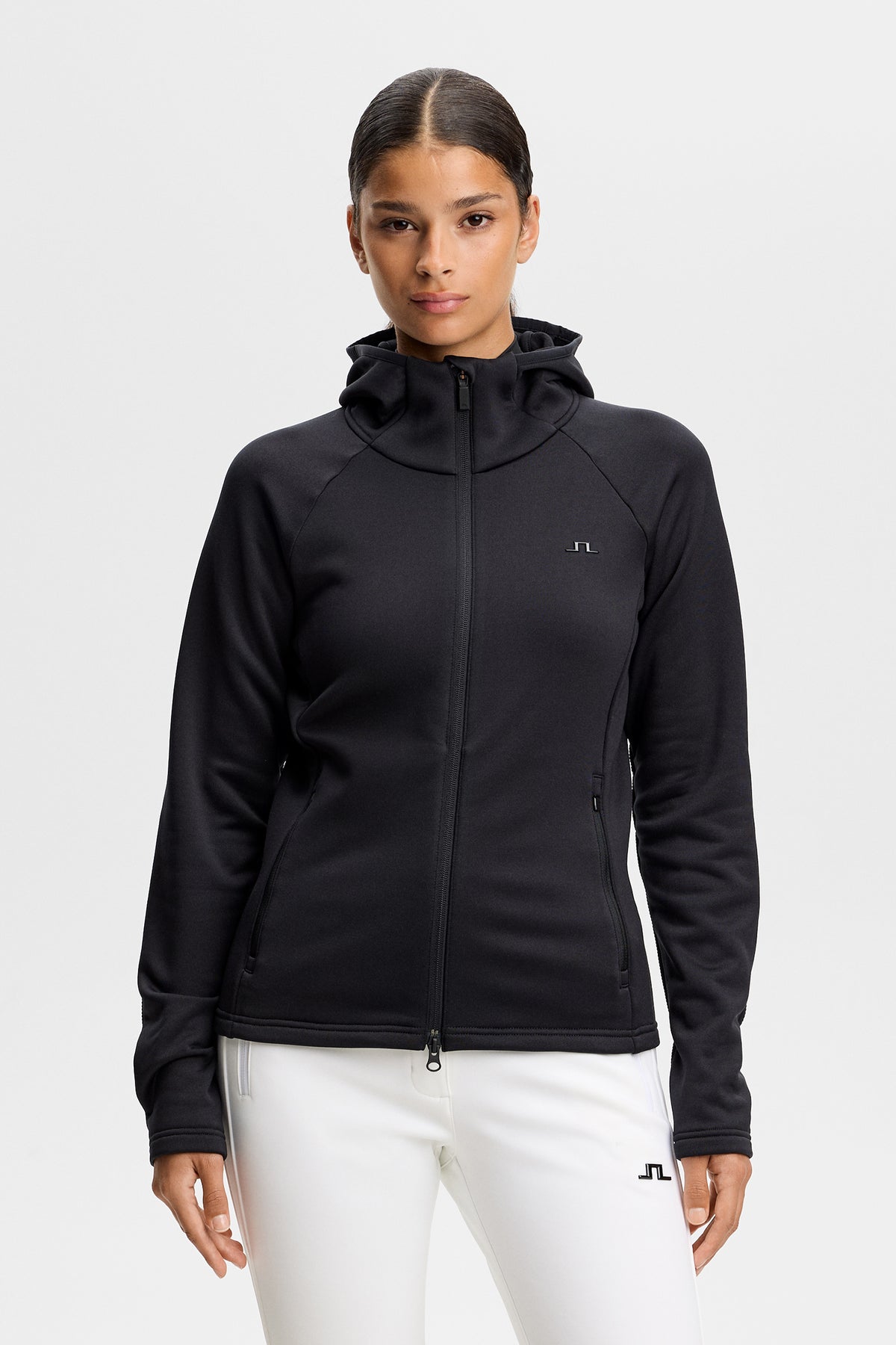 Set forfra: Sort Portia Polartec Hood med hætte, tovejslynlås, sidelommer og Bridge-logo på brystet.