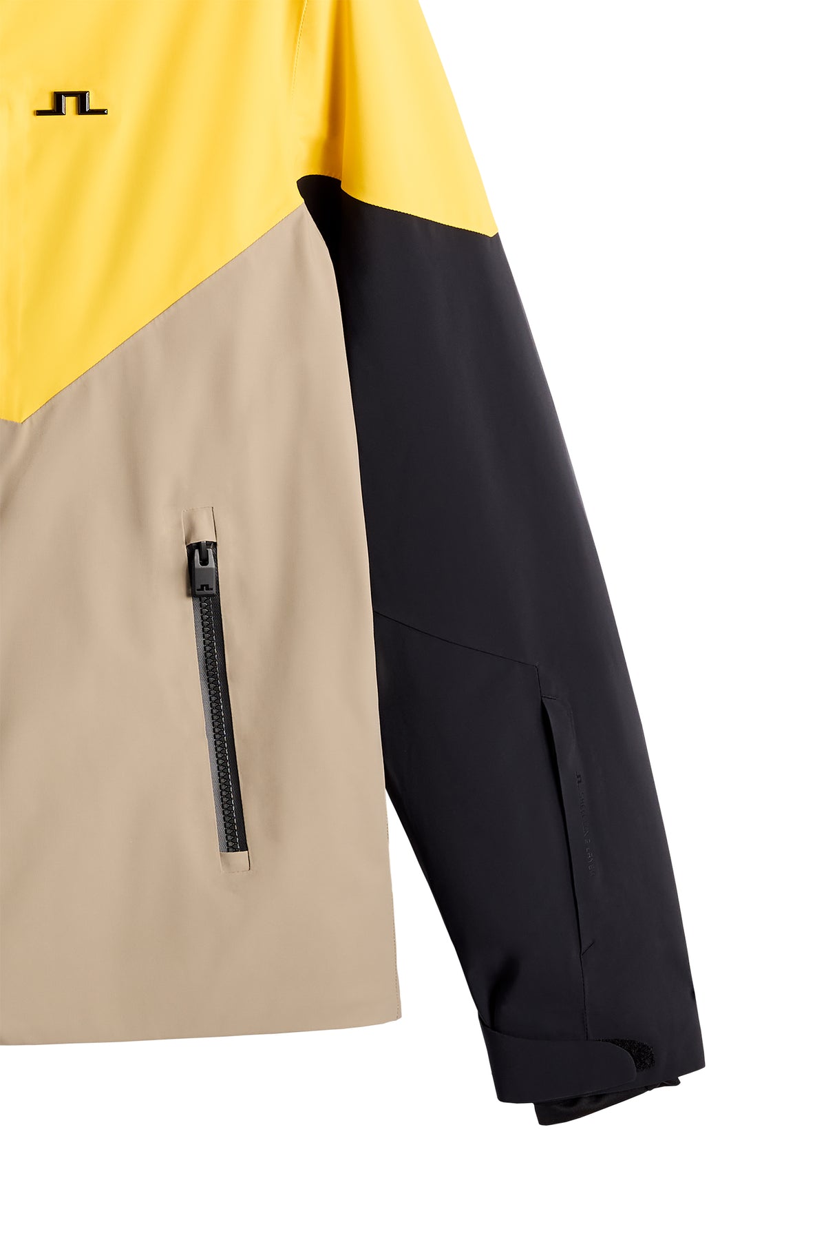 Nærbillede: Caldwell Jacket i Bumblebee med farveblokke, lynlåslomme og Bridge-logo på brystet.