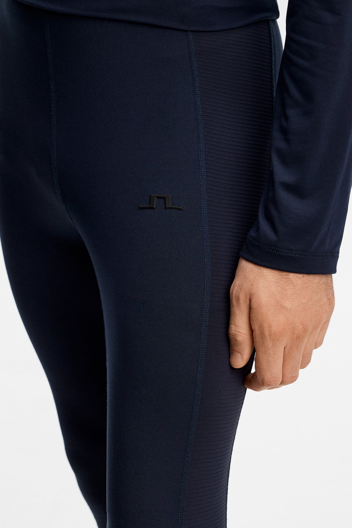 Close-up view: Zenit Baselayer Pant in JL Navy with tonal Bridge logo and flatlock seams.