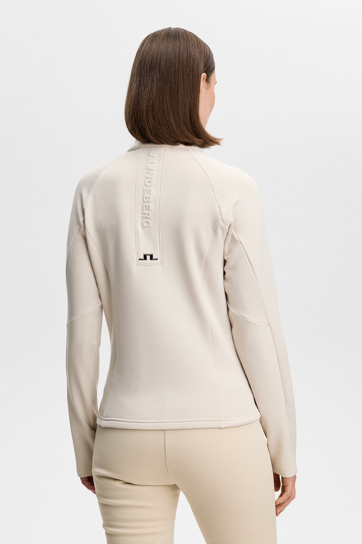 Portia Polartec Mid Layer in Moonbeam, back view with embossed logo and Bridge logo.