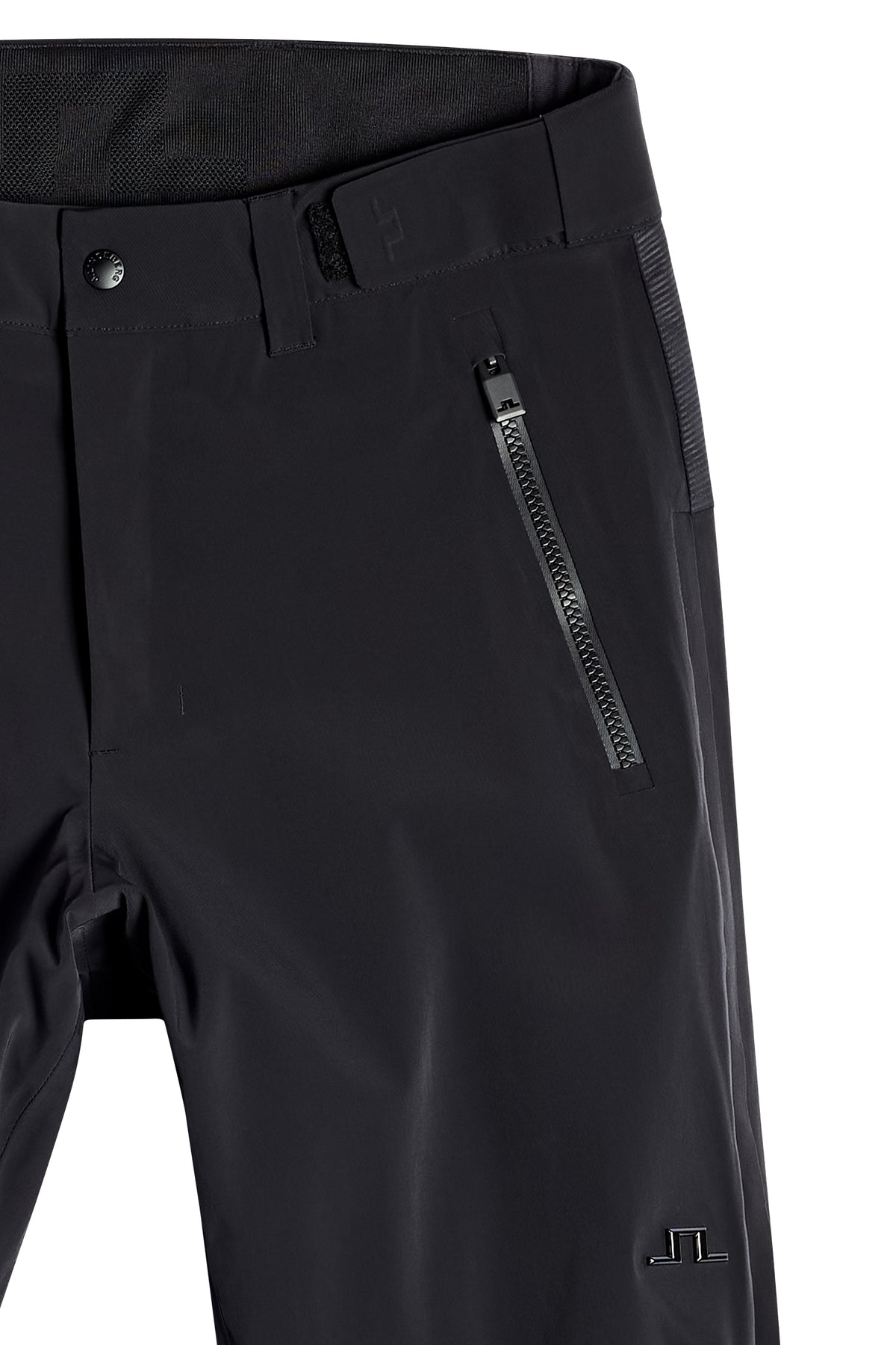 Close-up of the black Whitman Pant showing the waistband, zippered pocket, and Bridge logo.