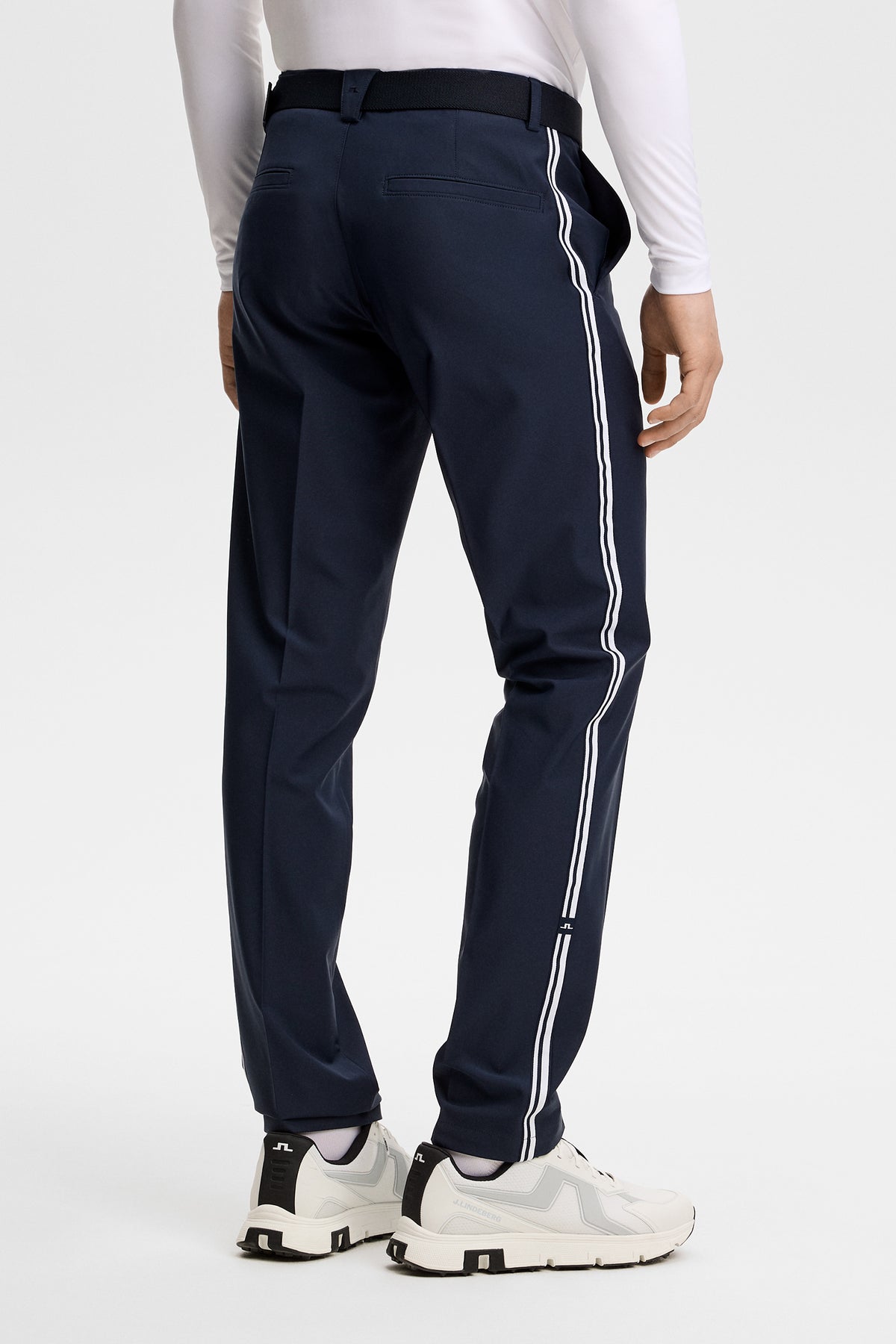 Mitch Stripe Pant in JL Navy, back three-quarter view showing white side stripes and a lower leg Bridge logo.